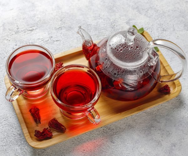 Hot Hibiscus tea in a glass mug and glass teapot.